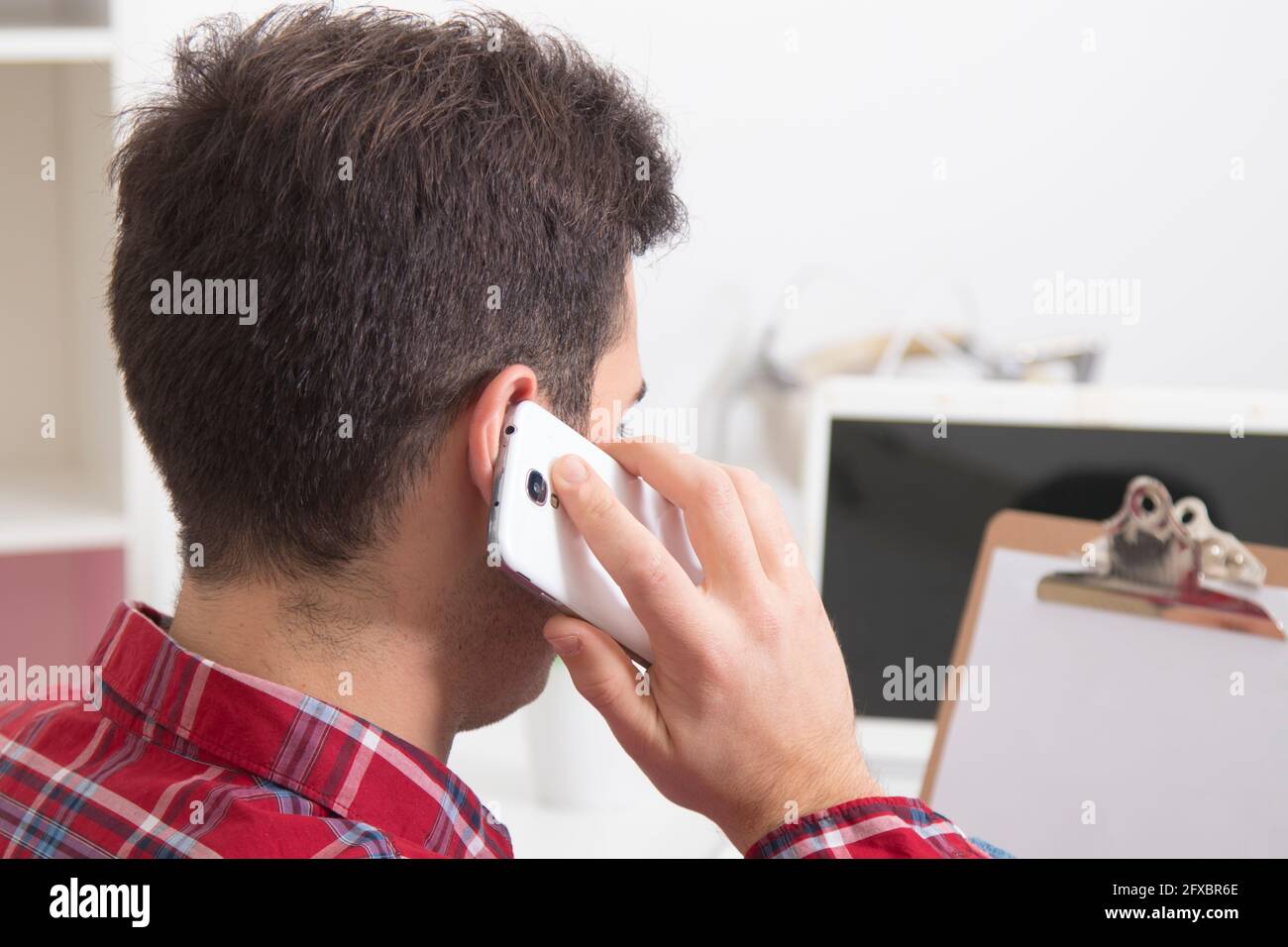 man talking on the phone at home in the office Stock Photo