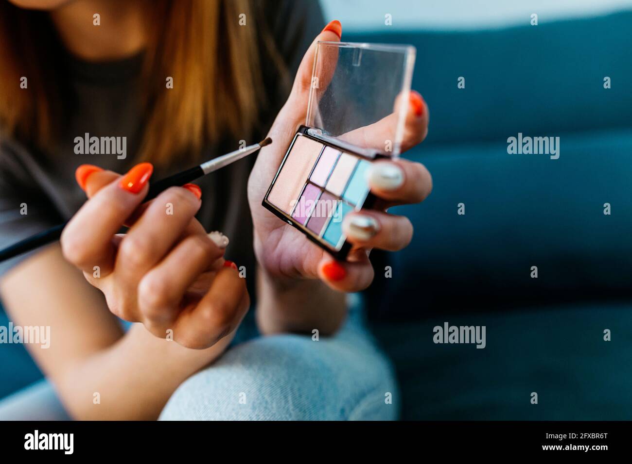 Young woman with brush holding make-up palette Stock Photo