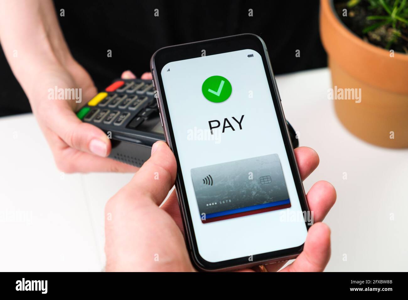Customer paying bill using mobile phone application and POS terminal machine. Wallet in smartphone Stock Photo