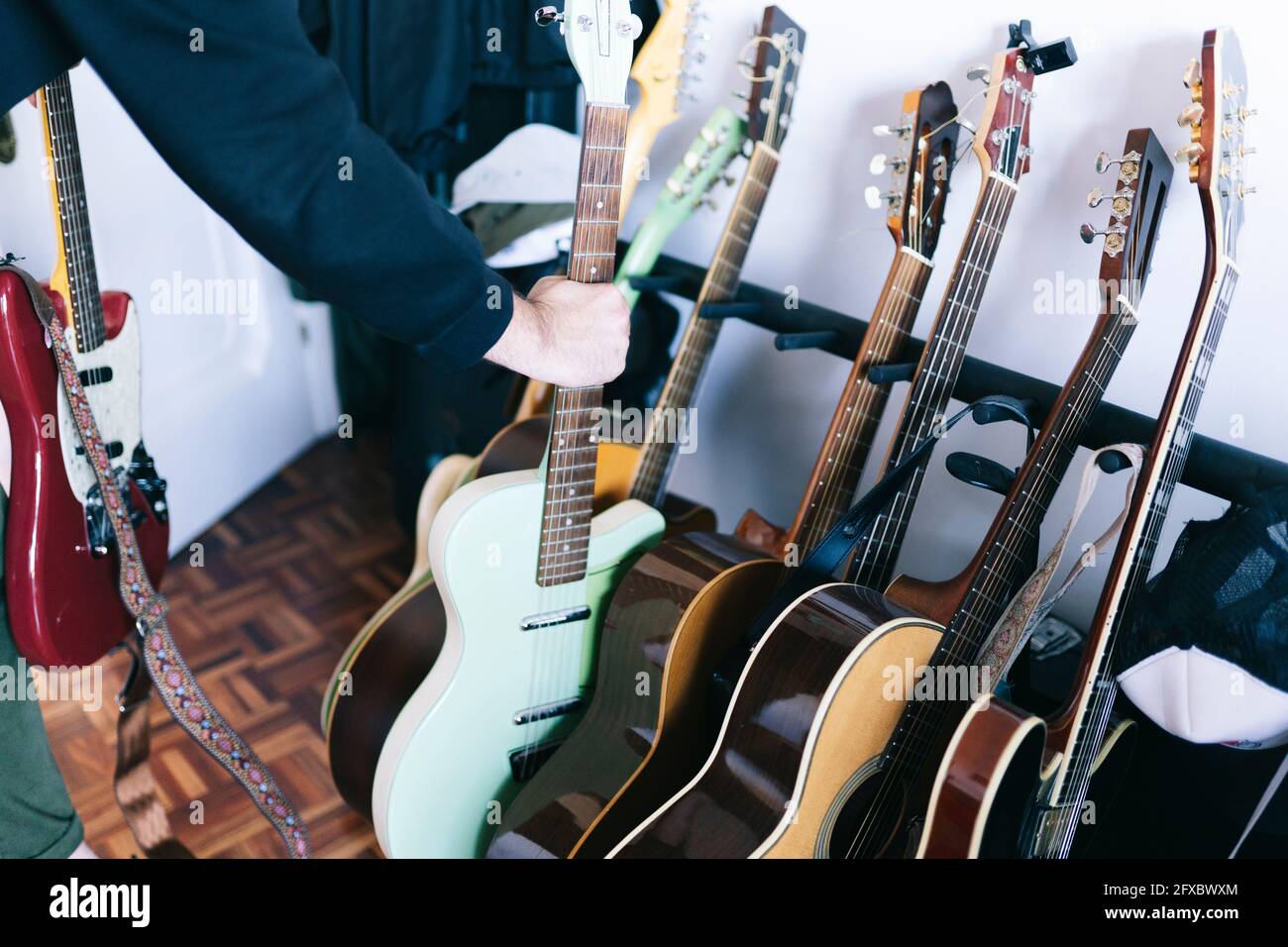 Man holding guitar at studio Stock Photo