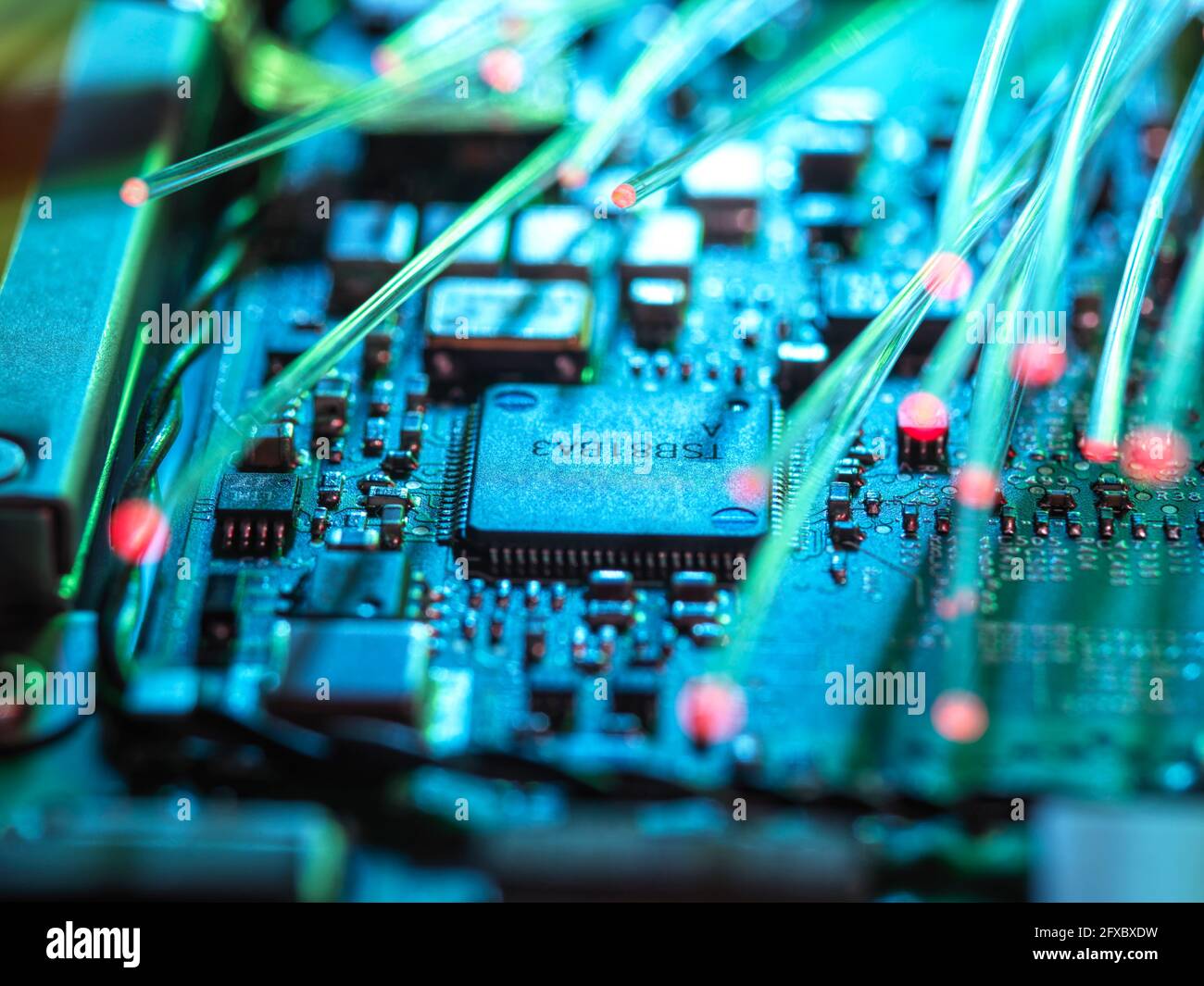 Fibre optics carrying data passing through laptop for cyber security Stock Photo