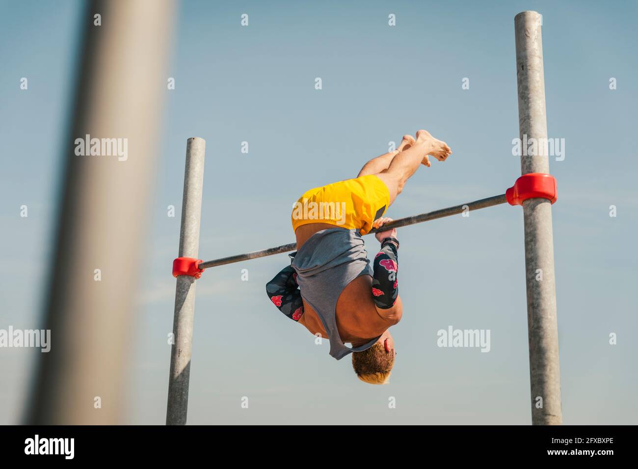 Athlete performing gymnastic on high bar Stock Photo Alamy