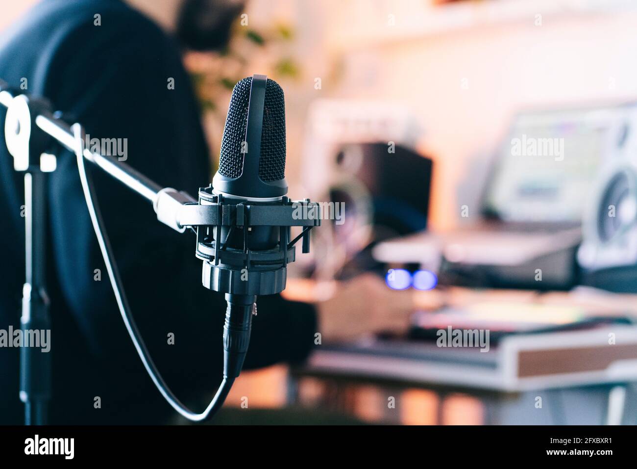 Condenser microphone on stand in studio Stock Photo