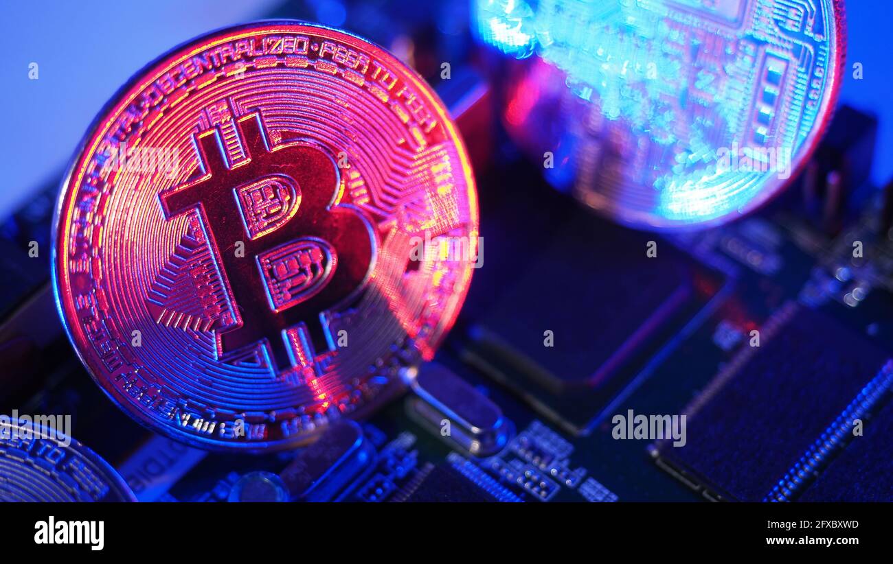 Bitcoin and semiconductor. Represent mining in Cryptocurrency cause global  warming. Bitcoins on CPU board. Close-up Bitcoin with blue and pink light  Stock Photo - Alamy