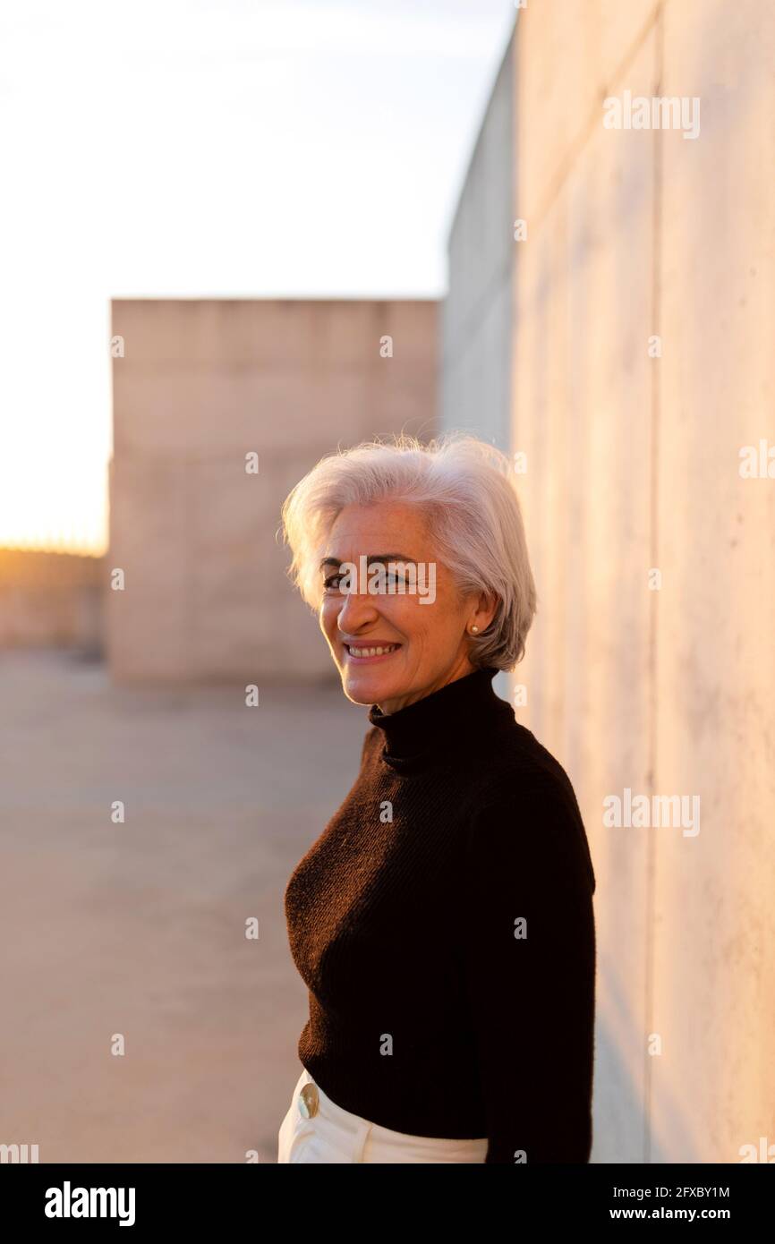 Mature positive woman standing hi-res stock photography and images - Alamy