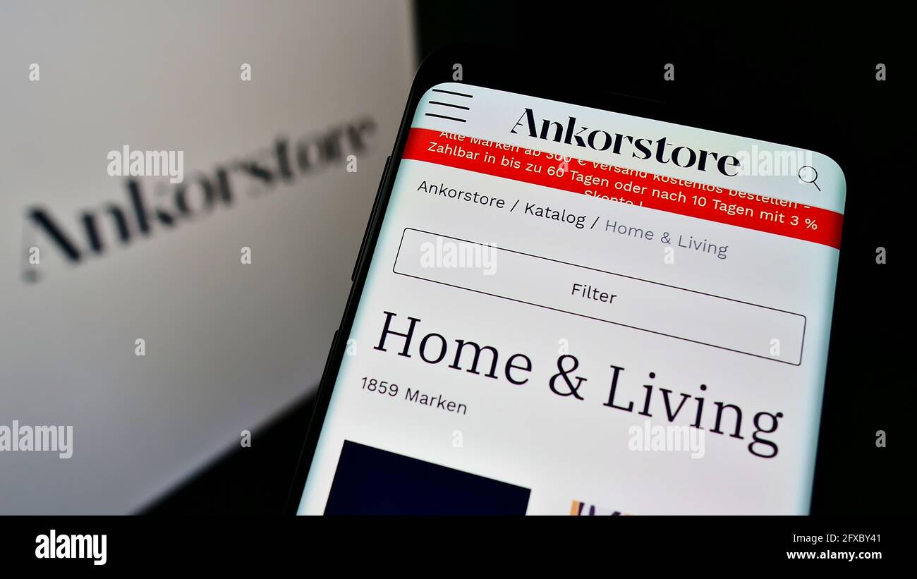 Cellphone with web page of French B2B marketplace company Ankorstore SAS on screen in front of business logo. Focus on top-left of phone display. Stock Photo