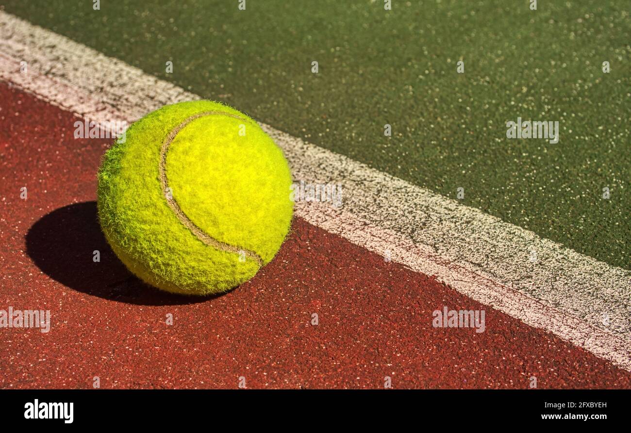 Tennis ball on the court, out of the line . A close up, sports photo concept Stock Photo