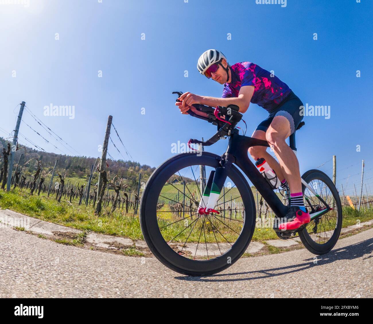 Active man riding racing bicycle on road Stock Photo