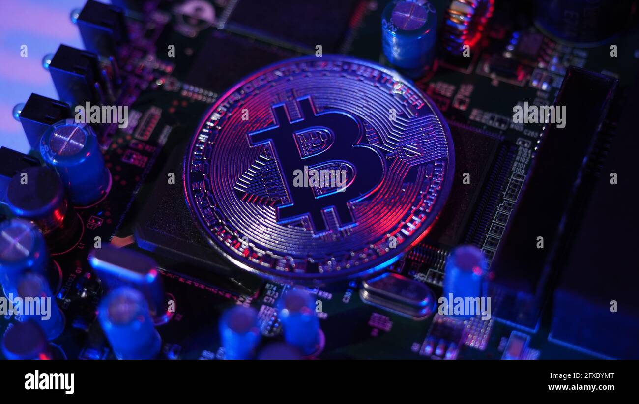 Bitcoin and semiconductor. Represent mining in Cryptocurrency cause global  warming. Bitcoins on CPU board. Close-up Bitcoin with blue and pink light  Stock Photo - Alamy