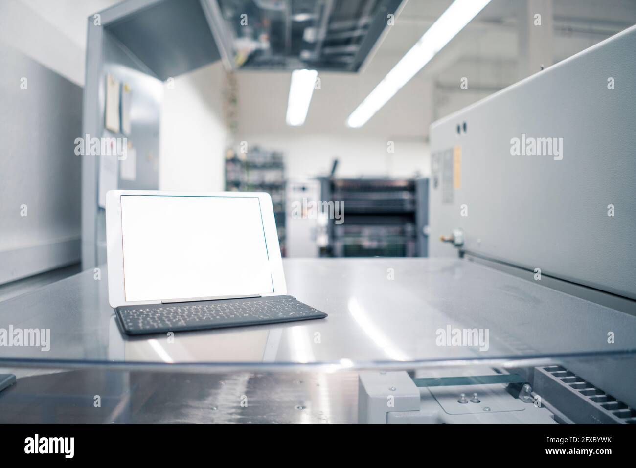 Digital tablet on glass table in industry Stock Photo