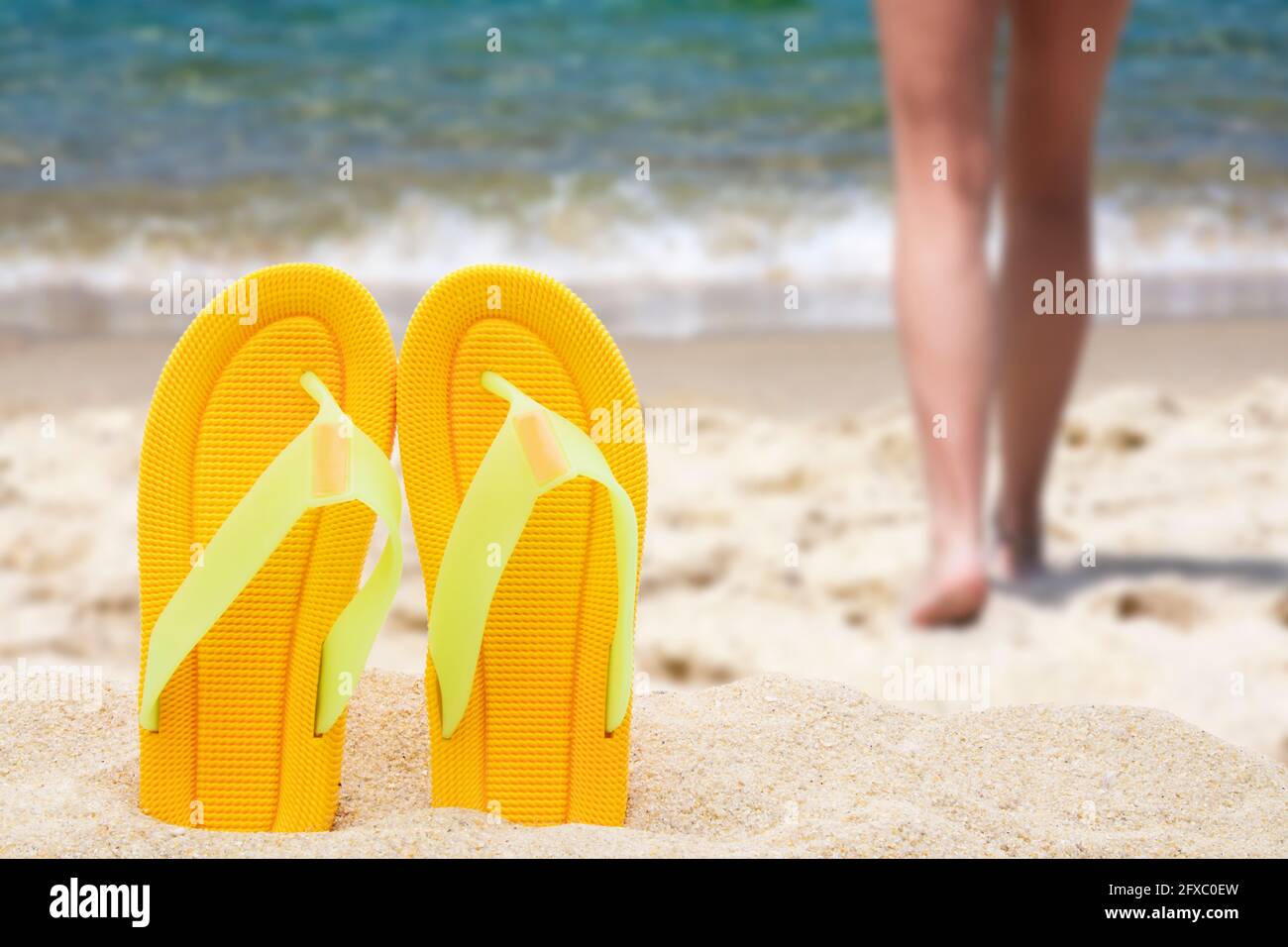 beach scenery with sandals in the sand Stock Photo - Alamy