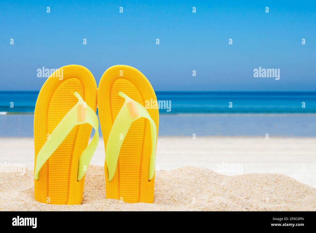 beach scenery with sandals in the sand Stock Photo - Alamy