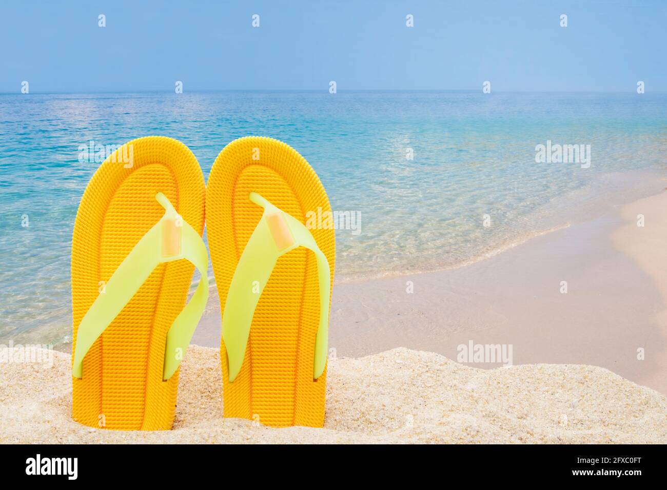 beach scenery with sandals in the sand Stock Photo - Alamy