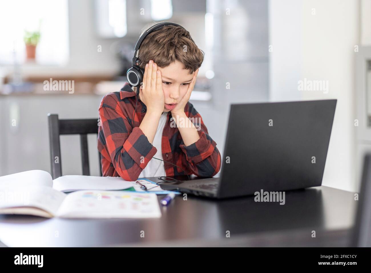 Boy in headphones sitting laptop hi-res stock photography and images ...