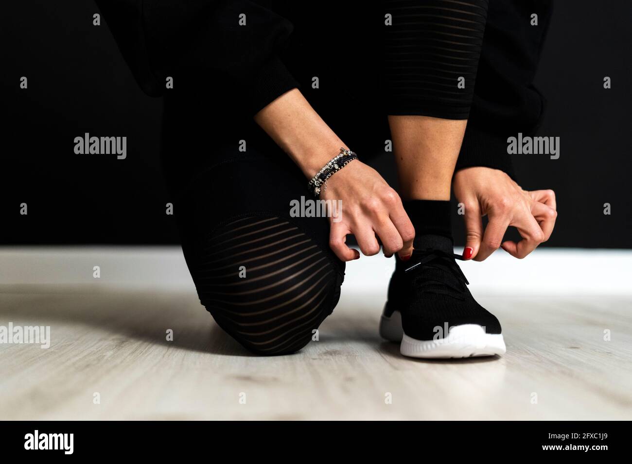 Female sportsperson tying shoelace Stock Photo