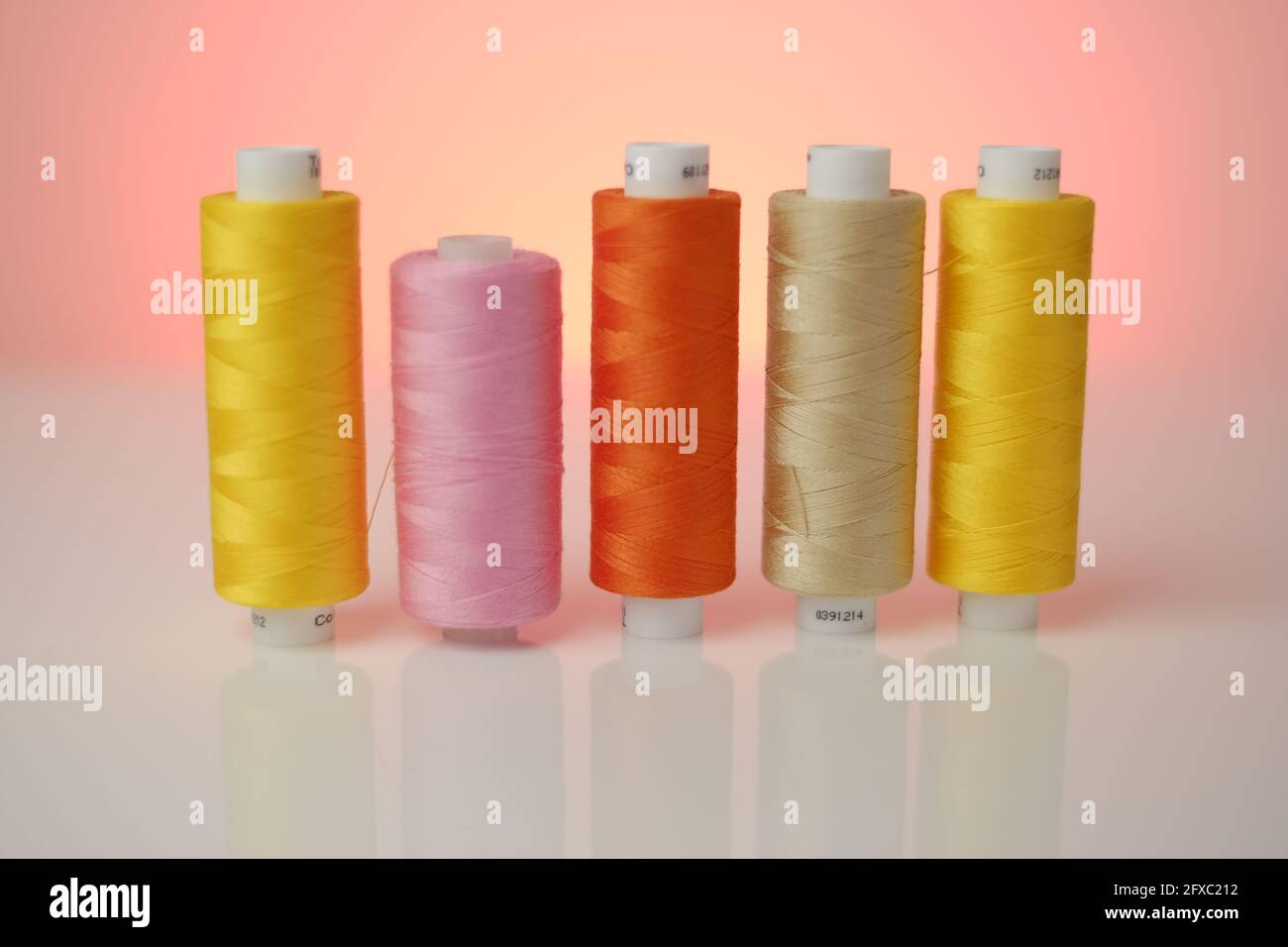 Sewing threads.Multicolored threads set. Yellow, orange and pink