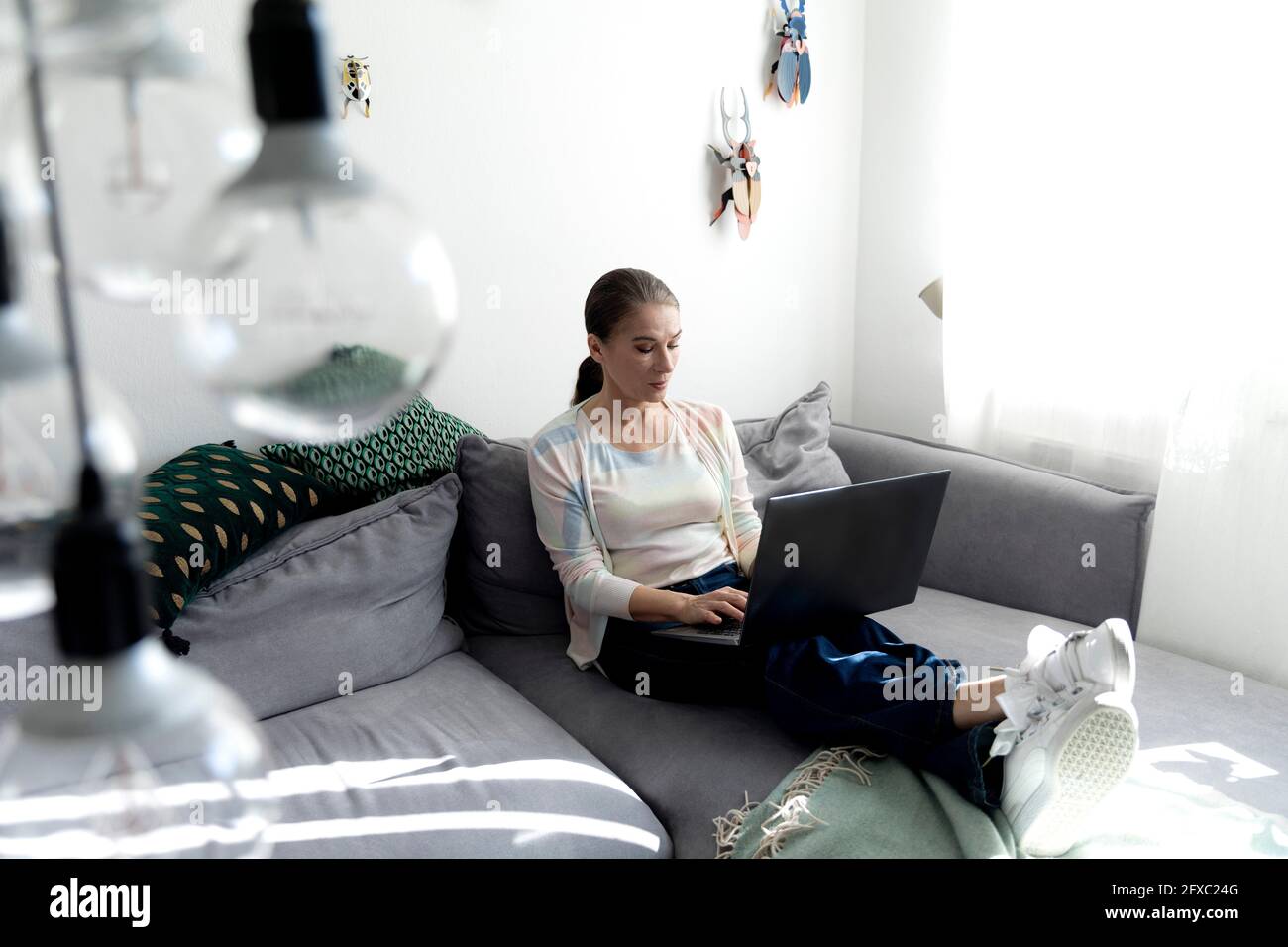 Mature woman using laptop while working at home Stock Photo