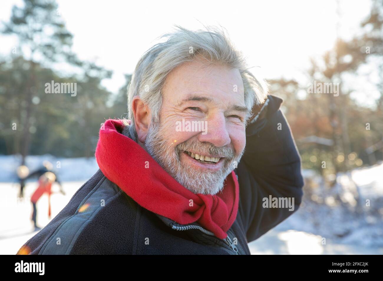 Happy senior man with red scarf during winter Stock Photo