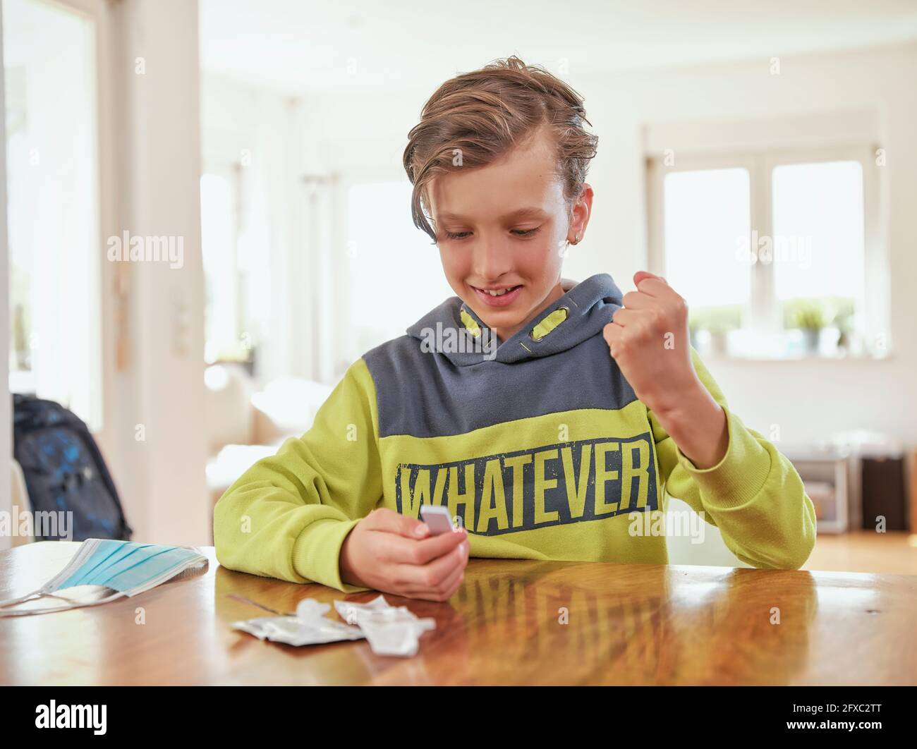 Happy boy with medical test kit at home Stock Photo