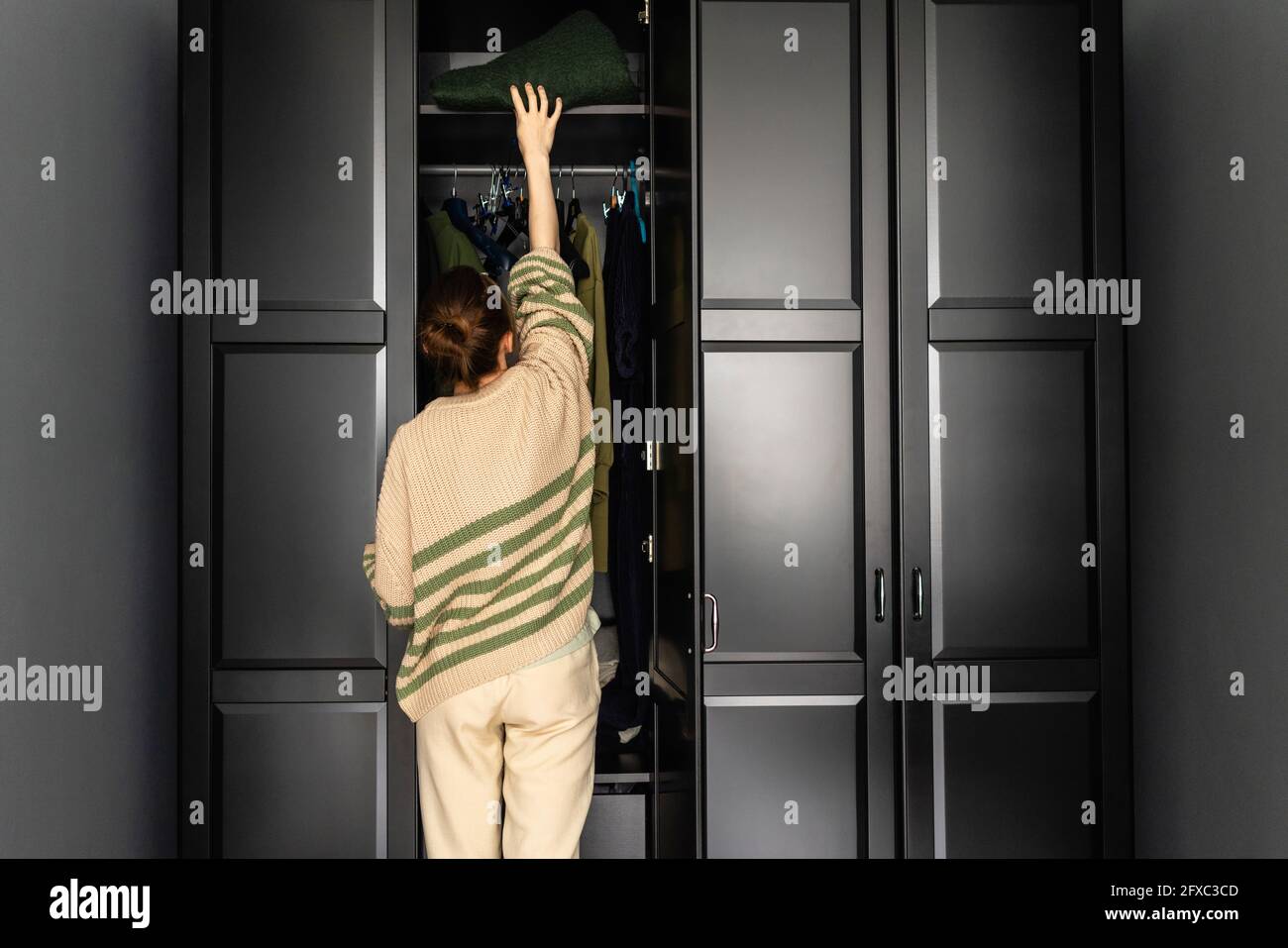 Woman removing clothes hires stock photography and images Alamy