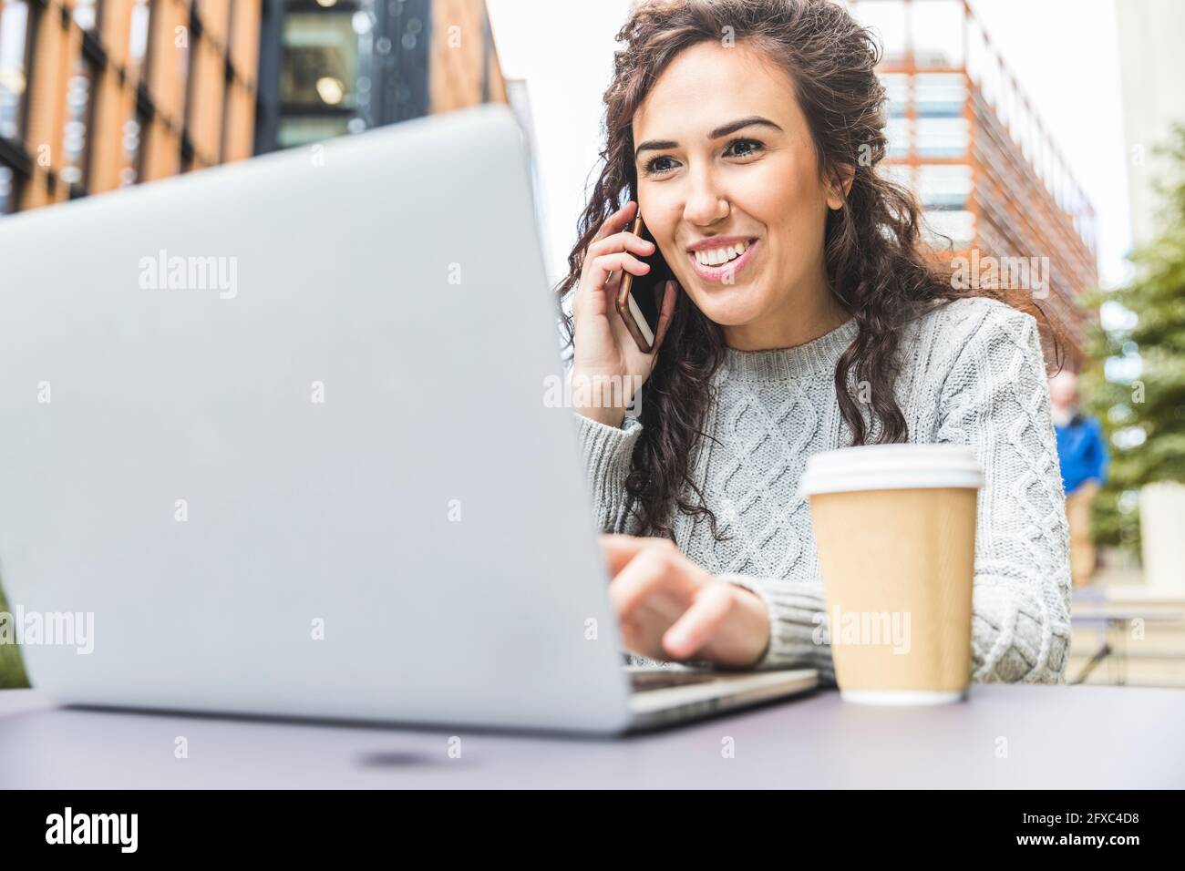 Beautiful female entrepreneur using laptop at cafe in city Stock Photo