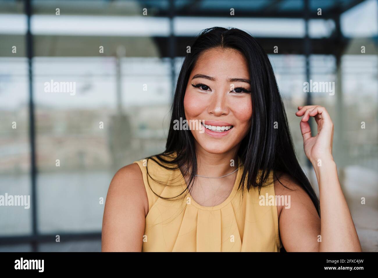 Smiling businesswoman at office cafeteria Stock Photo