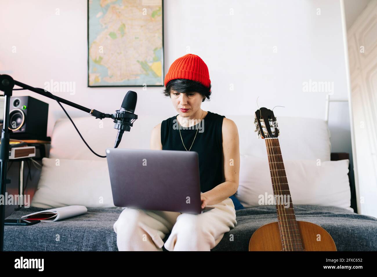 Female music composer using laptop in recording studio Stock Photo