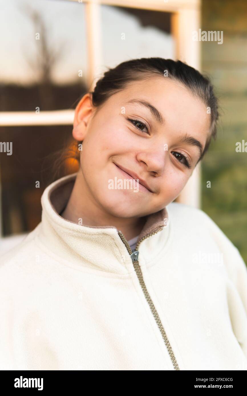 Smiling girl with head cocked Stock Photo