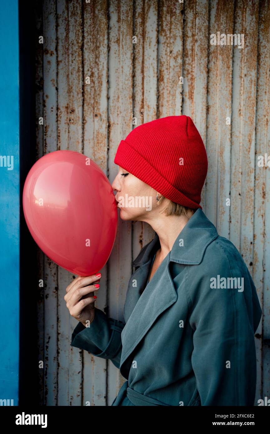Woman kissing balloon Photos