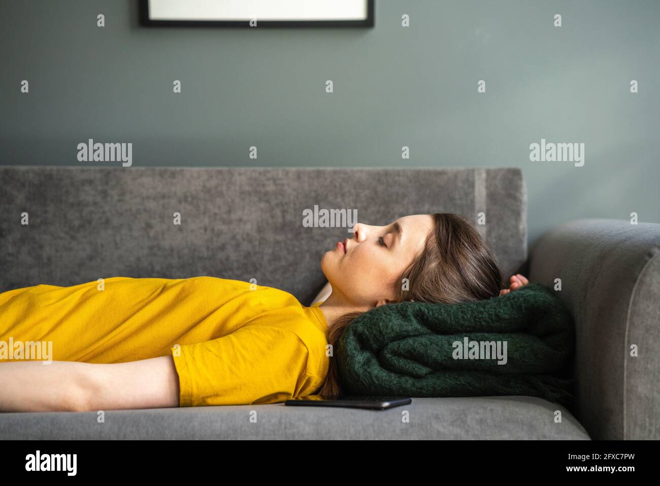 Woman relaxing on sofa hi-res stock photography and images - Alamy