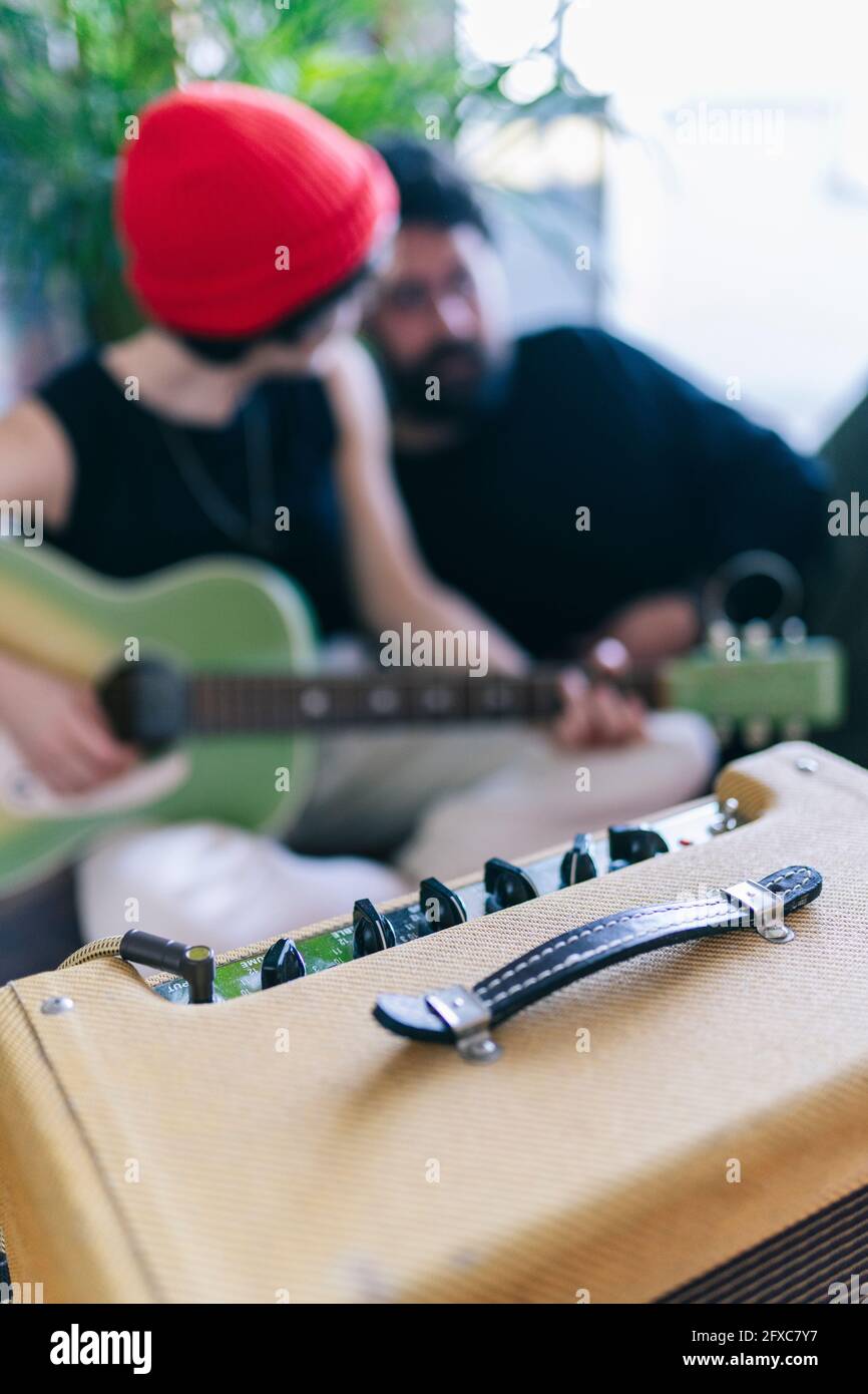 Male and female musicians with musical instruments in studio Stock Photo