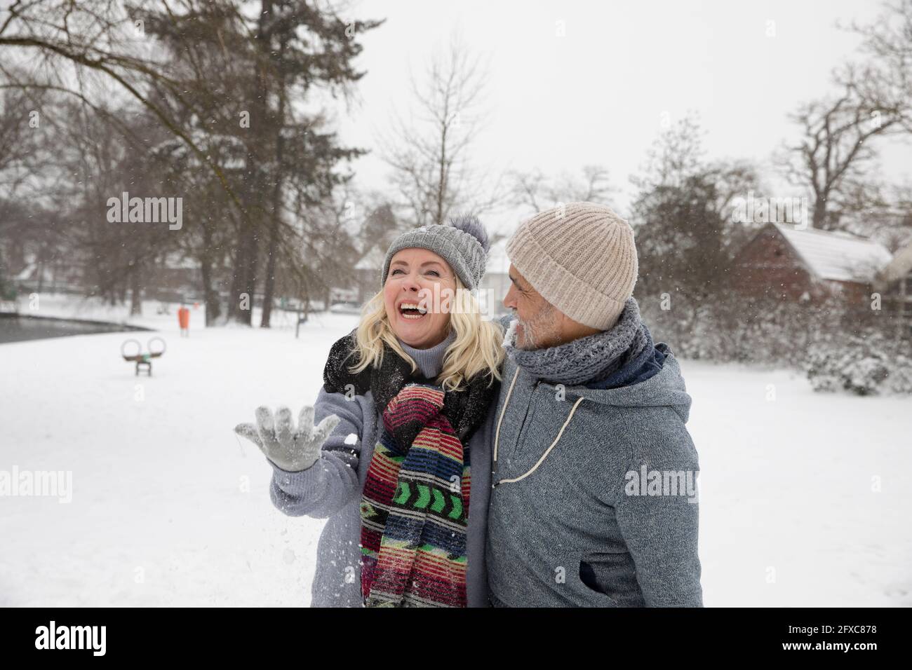 Happy couple in snow during winter Stock Photo