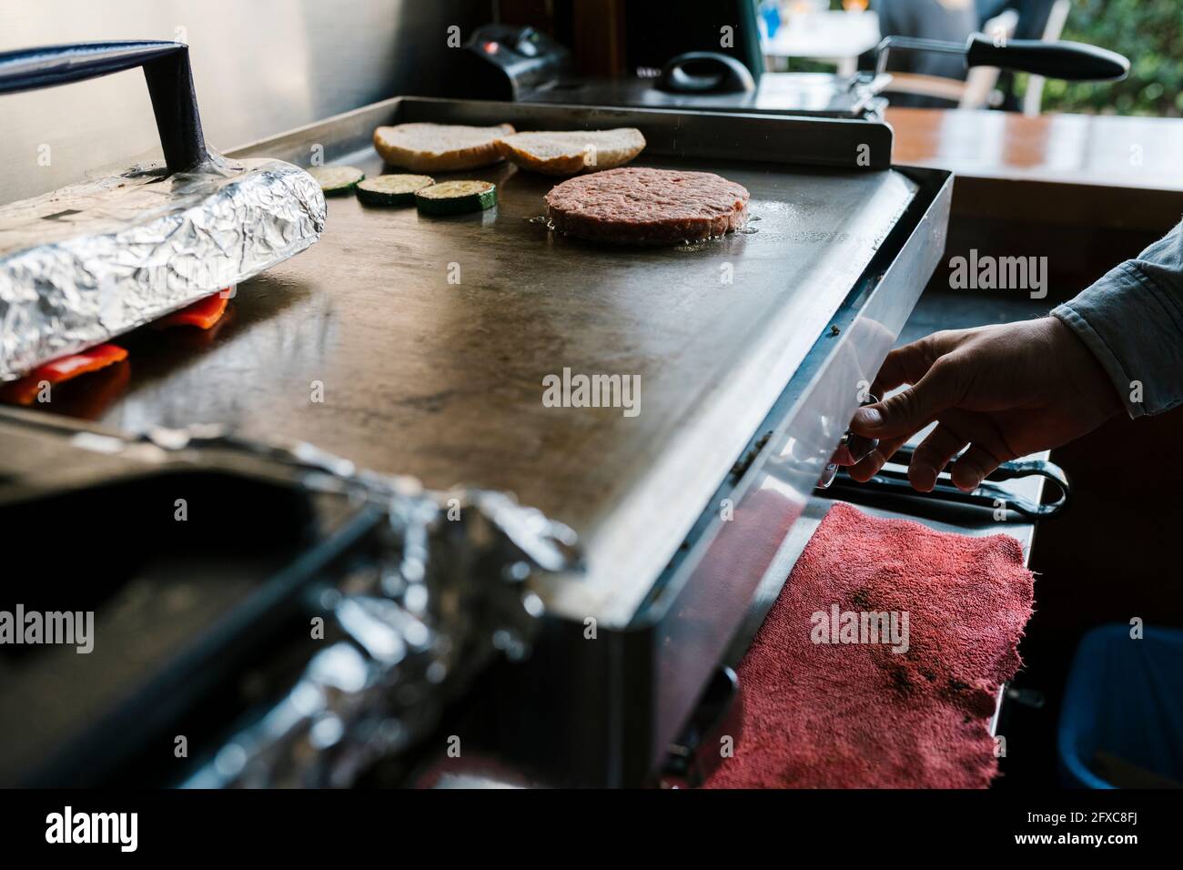 Burger patty on griddle at restaurant Stock Photo