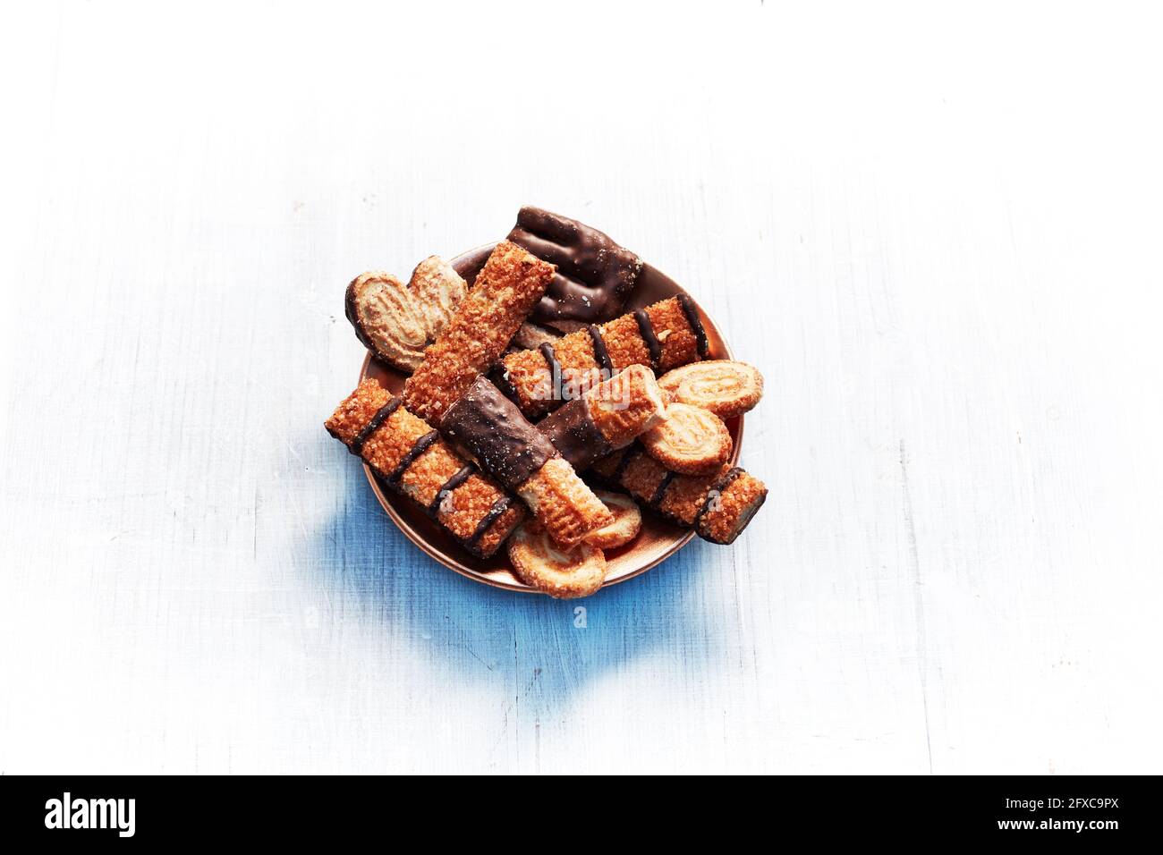 Plate of cookies with chocolate against white background Stock Photo