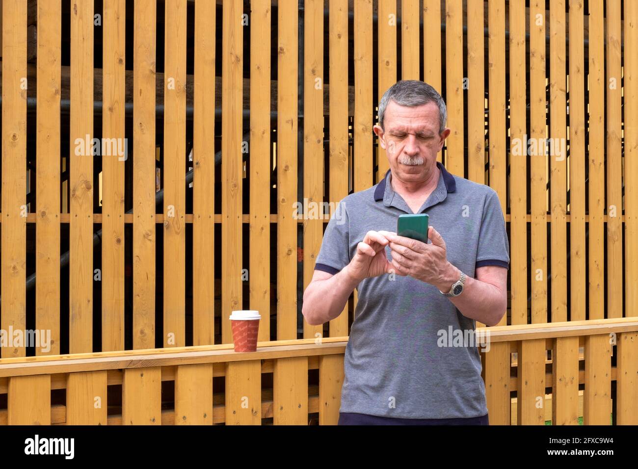 An adult pensioner touches the smartphone screen Stock Photo