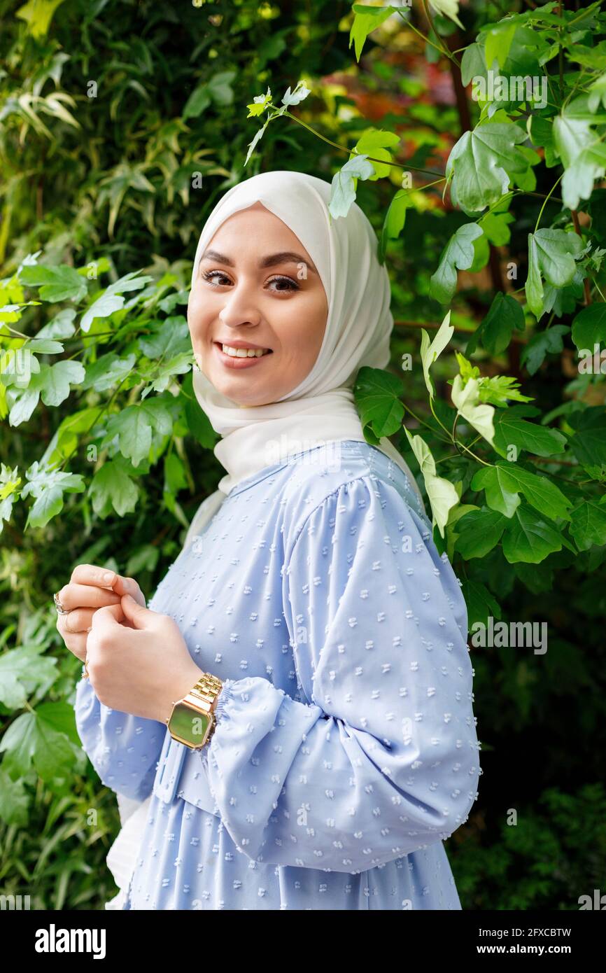 Young woman wearing hijab standing amidst leaves Stock Photo - Alamy