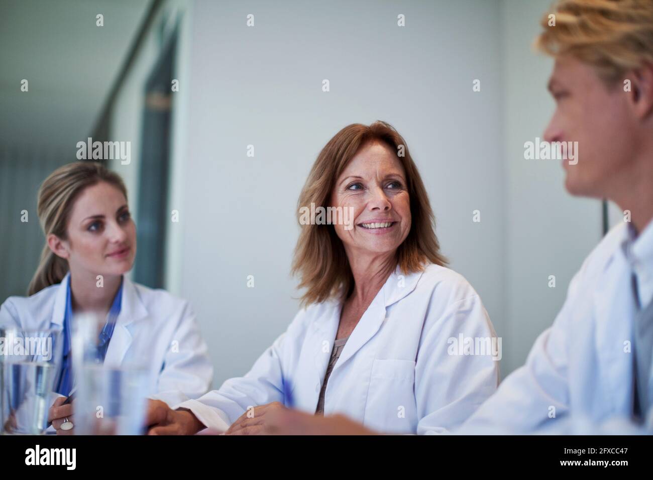 Female doctors smiling at male colleague in hospital Stock Photo