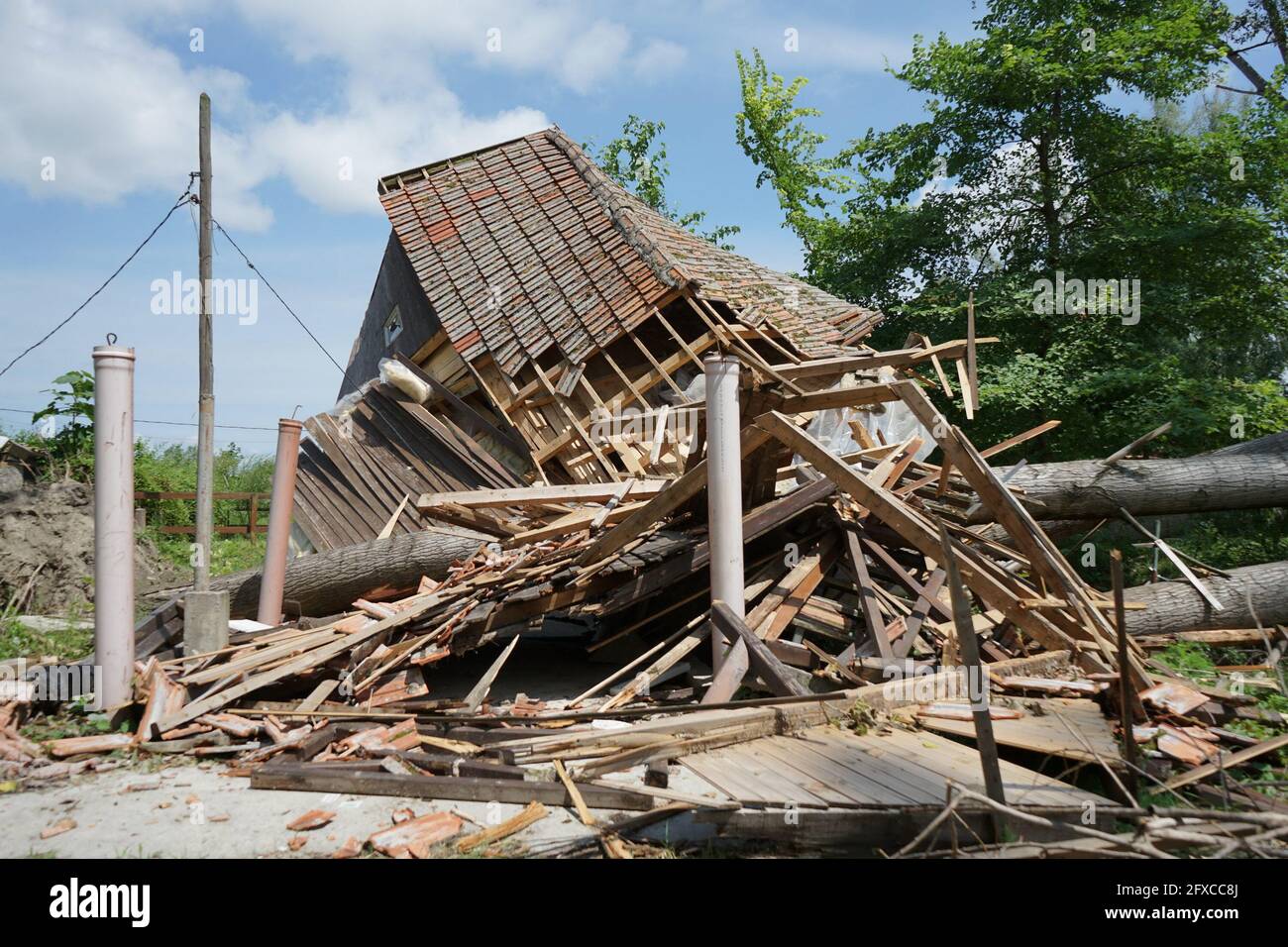 House damaged by hurricane storm with a fallen tree in front Stock ...