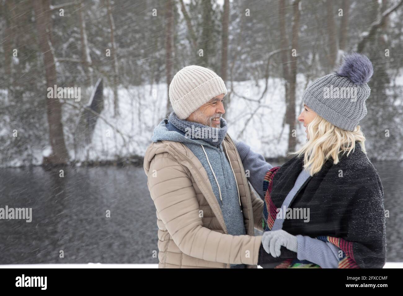 Senior couple smiling while looking at each other Stock Photo - Alamy