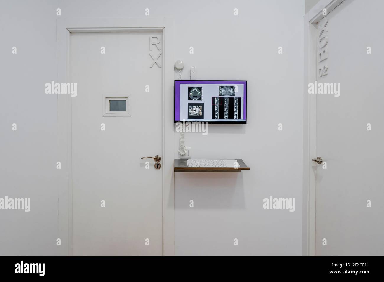 Closed doors by flat screen at medical clinic Stock Photo