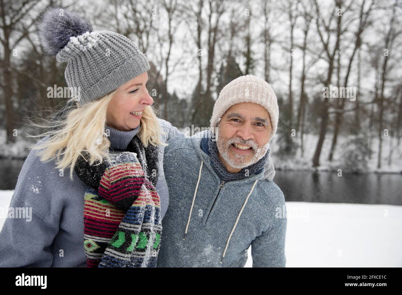 Cheerful senior couple playing outdoors during winter Stock Photo