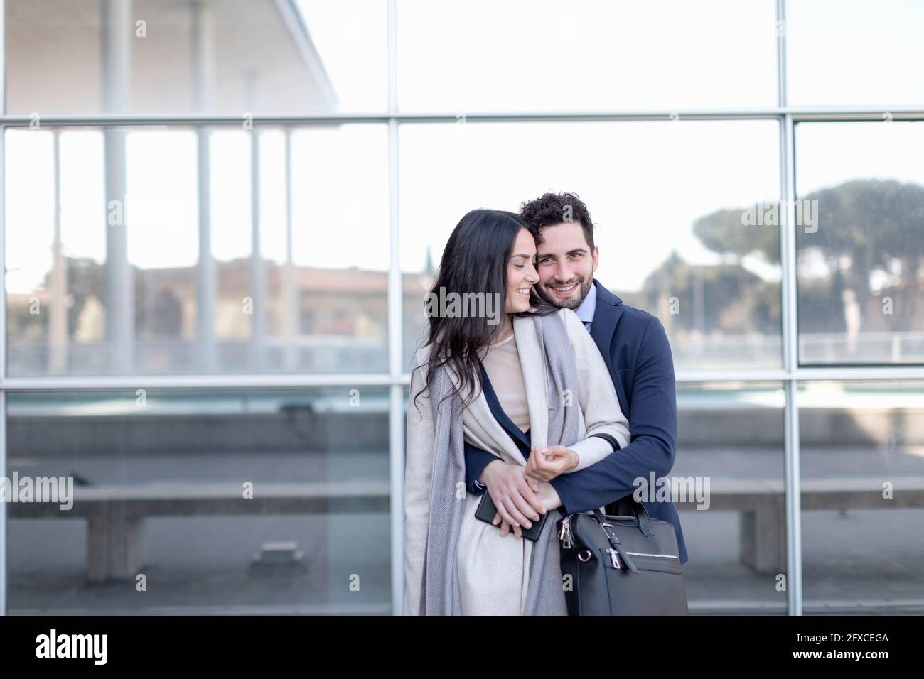 Smiling business couple standing together in front of building Stock Photo