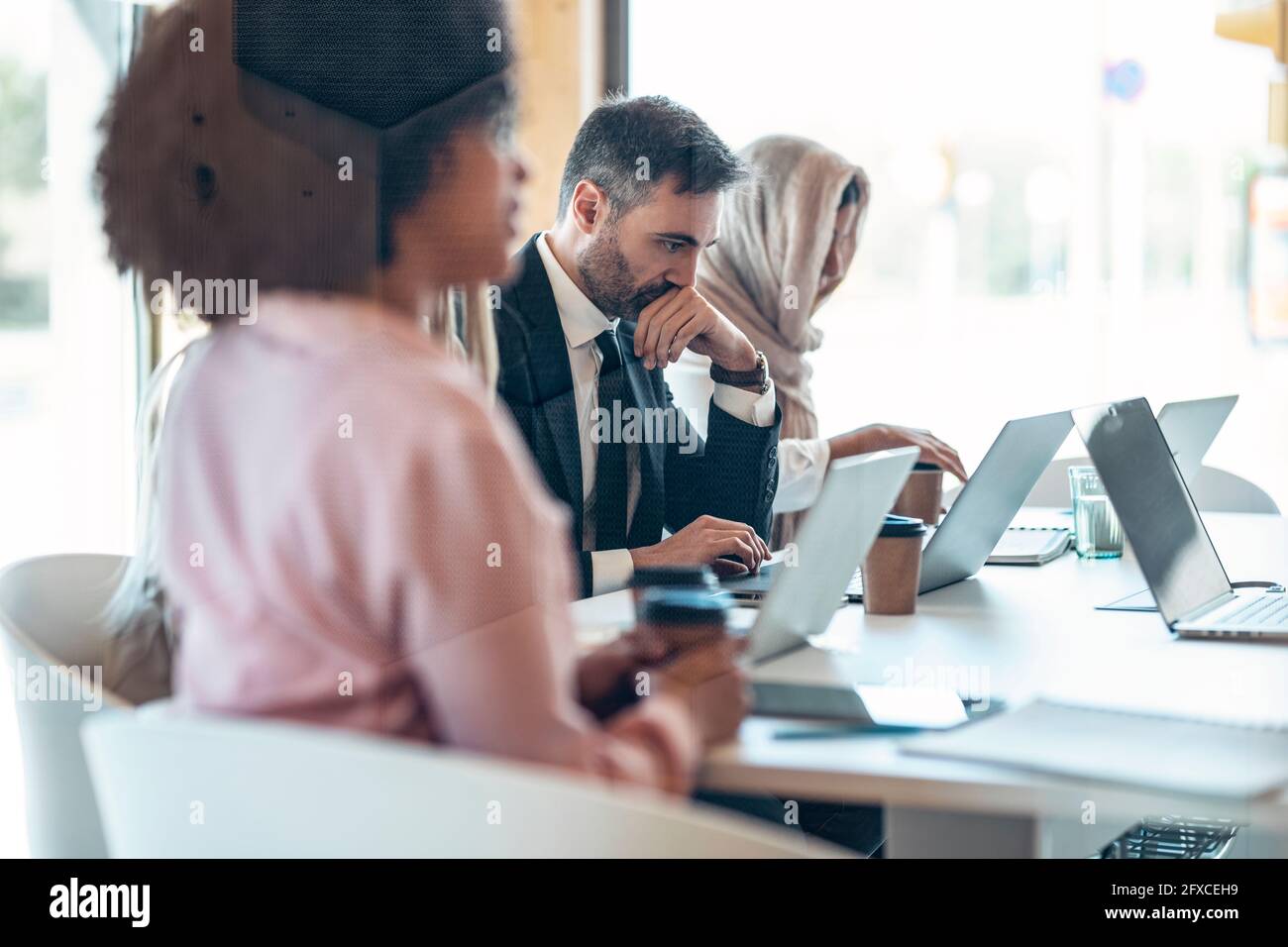Multi-ethnic male and female professionals working in office Stock Photo