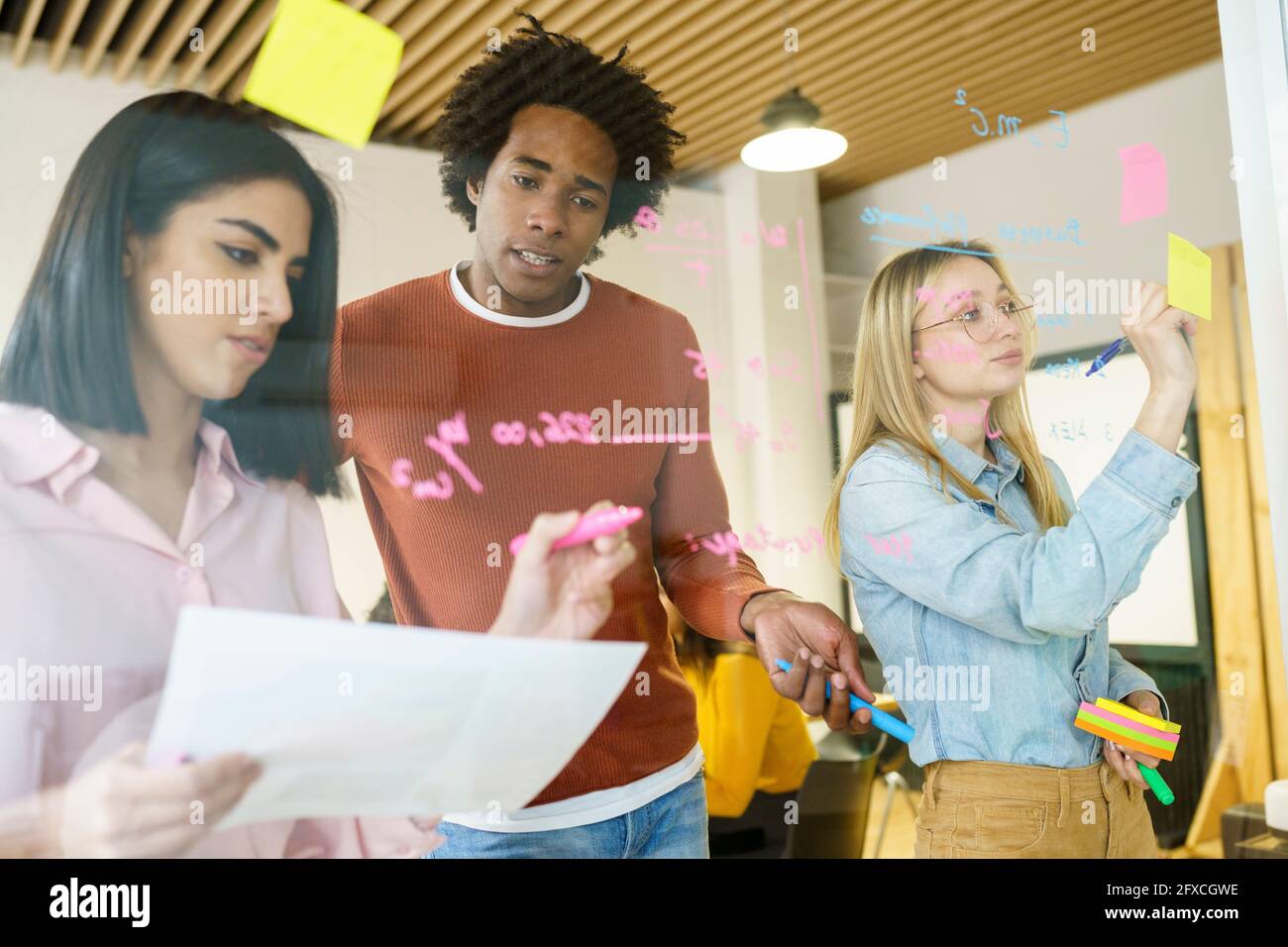 Multi-ethnic creative professionals planning in office Stock Photo