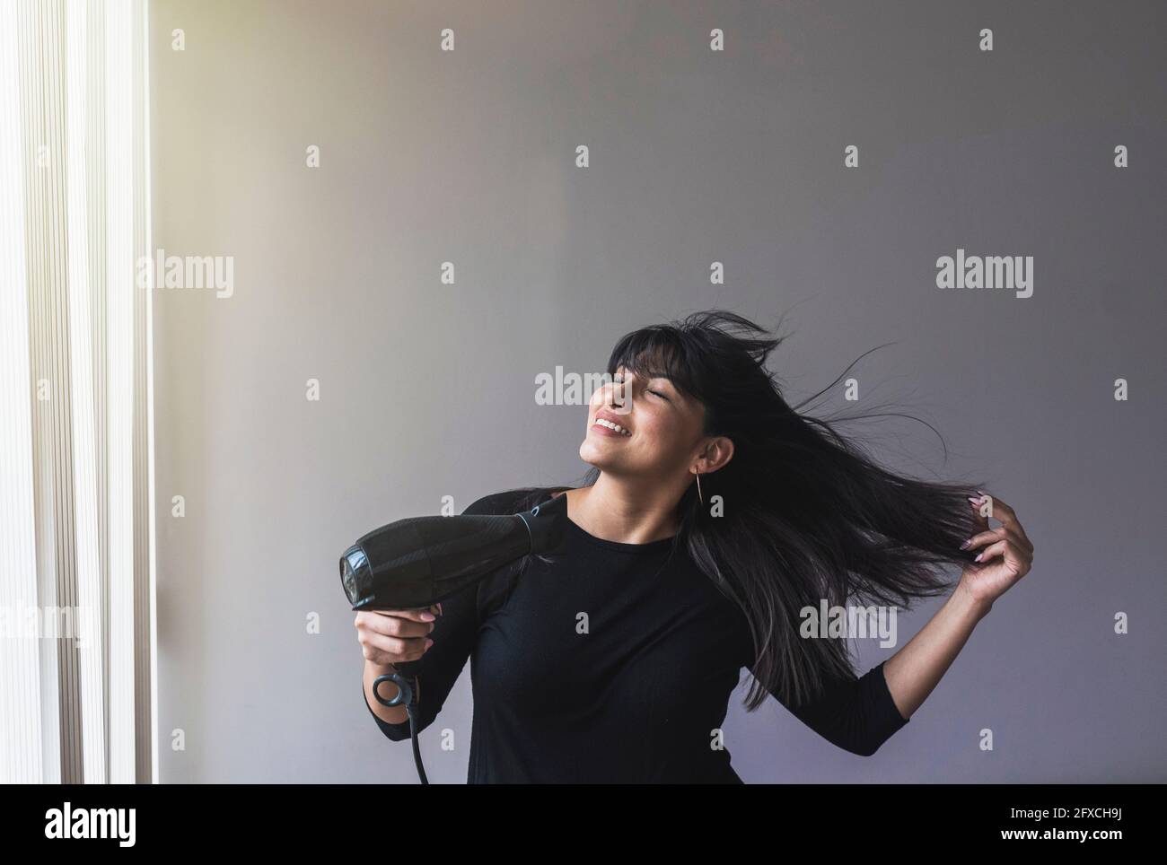 Black woman hair dryer hi-res stock photography and images - Alamy