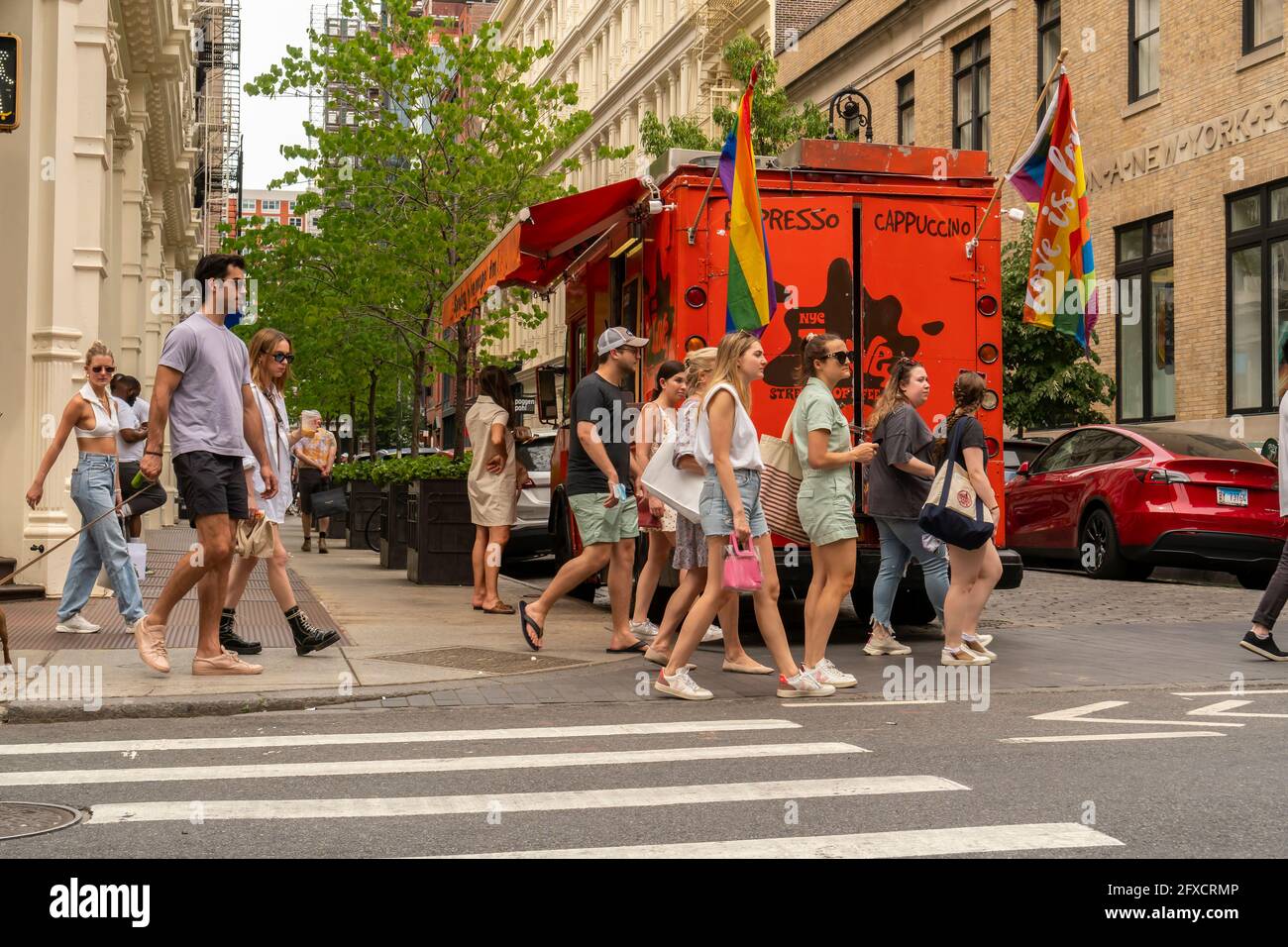 Mostly mask-less people in the Soho neighborhood in New York on Saturday, May 22, 2021. New York has relaxed mask mandates allowing most outdoor activities to be mask free as well as many indoor settings, with caveats. (© Richard B. Levine) Stock Photo
