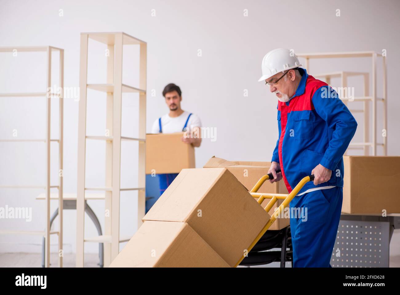 Two professional movers doing home relocation Stock Photo