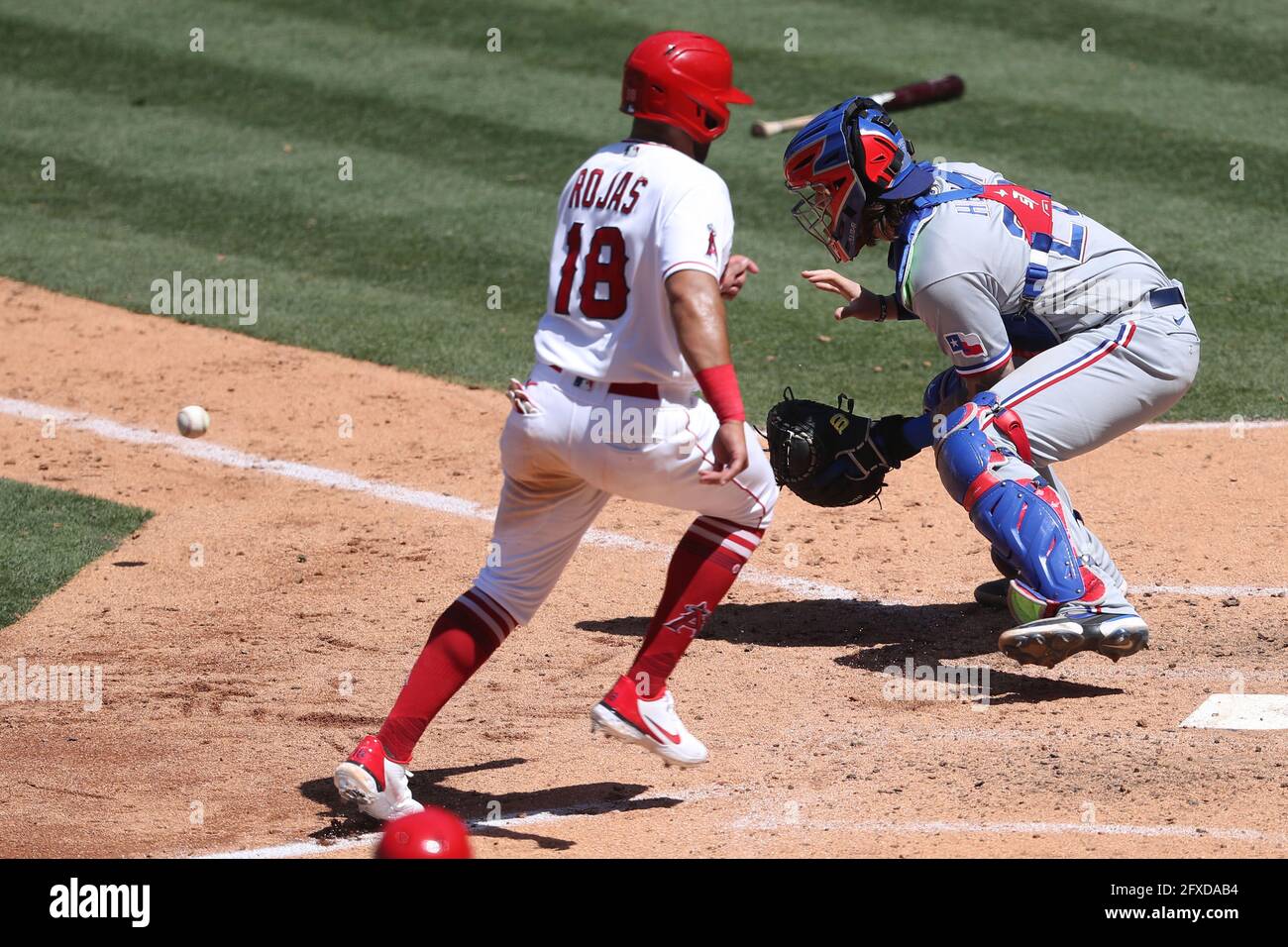 May 26, 2021: Los Angeles Angels third baseman Jose Rojas (18) beats the throw to Texas Rangers catcher Jonah Heim (28) at home plate during the game between the Texas Rangers and the Los Angeles Angels of Anaheim at Angel Stadium in Anaheim, CA, (Photo by Peter Joneleit, Cal Sport Media) Stock Photo