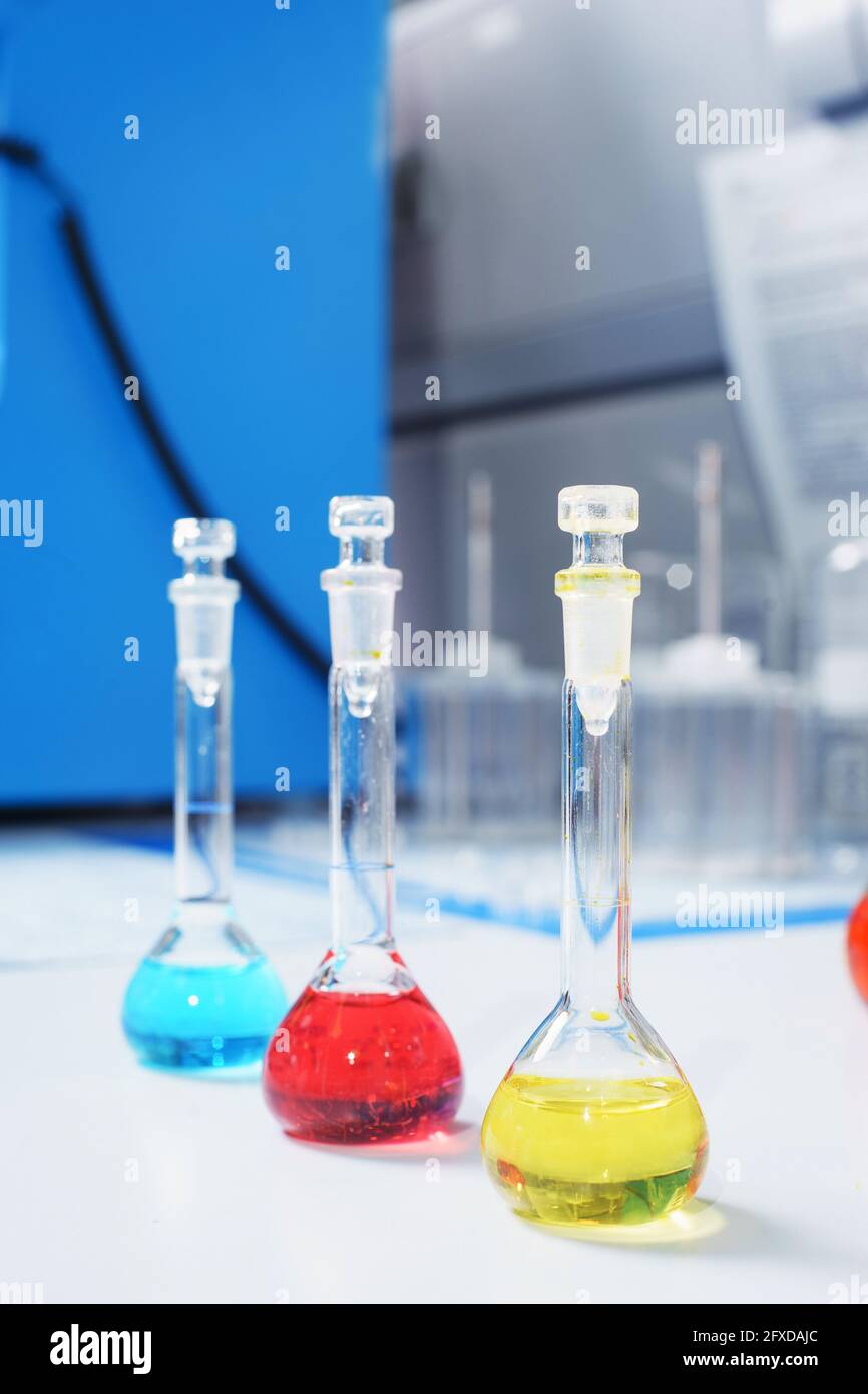 Test tubes and flasks with test liquid on the table in a chemical lab ...