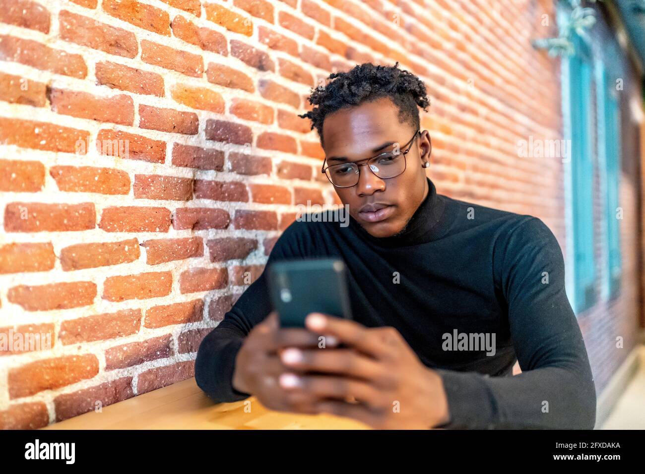 young african man working from his smartphone Stock Photo